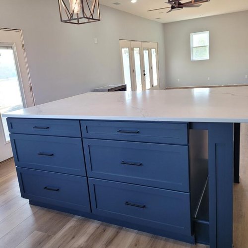 Kitchen with blue cabinetry by Xtreme Wholesale