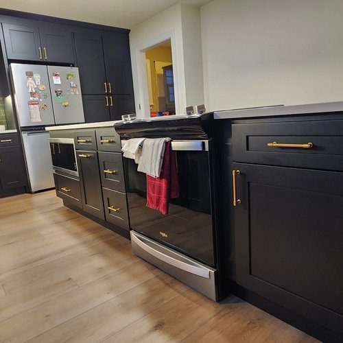 Remodeled Kitchen with Green Backsplash by Xtreme Wholesale